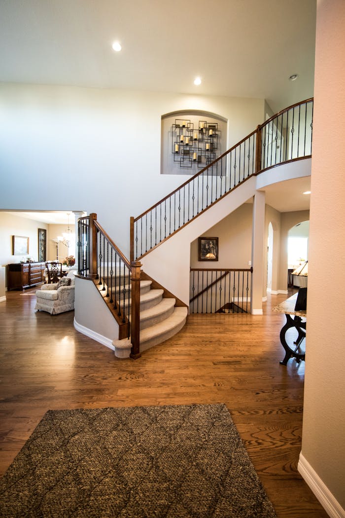 gallery-04 Spacious modern interior showcasing a stylish wooden staircase and elegant decor.