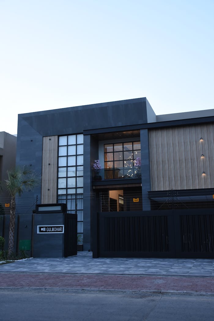 Contemporary house in Lahore showcasing sleek design with glass and wood elements.