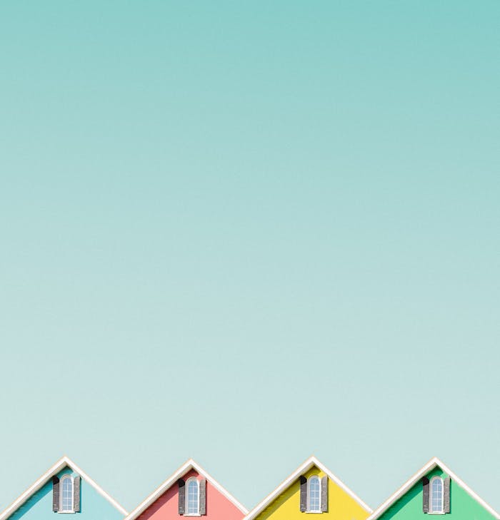 gallery-03 Aesthetic view of vibrant house roofs under a clear turquoise sky in Buffalo, NY.